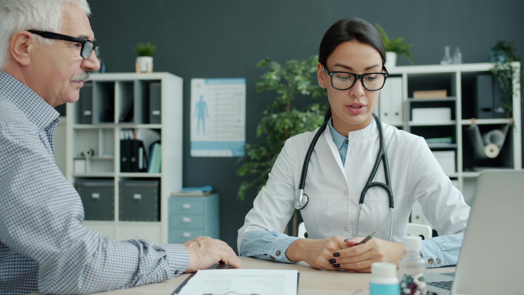 A doctor consulting with an older patient in an office