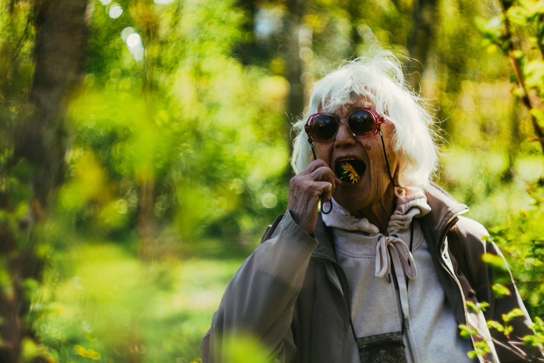An older woman with white hair talking on the phone